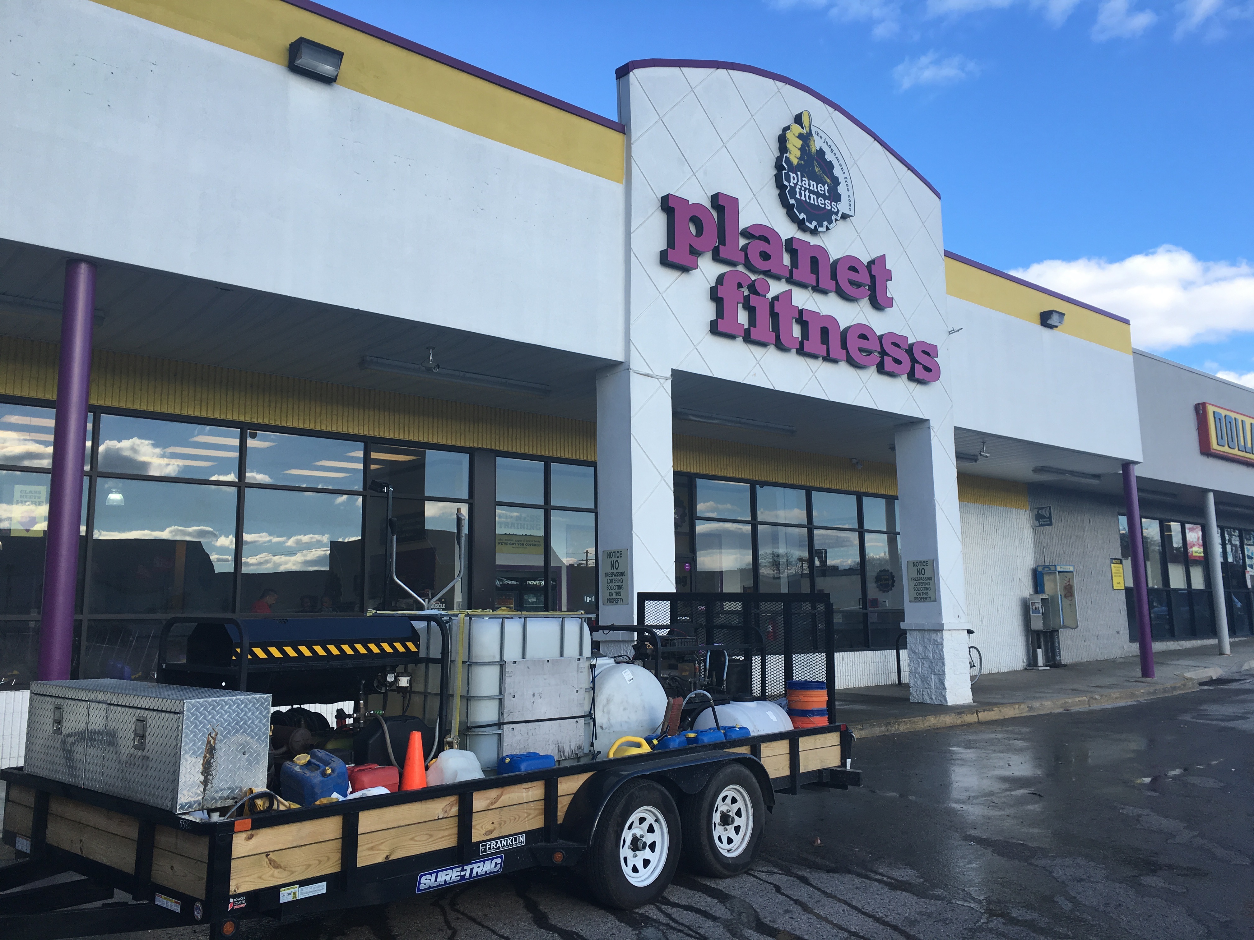 Pressure Wash Company Trailer Cleaning a Commercial Shopping Center