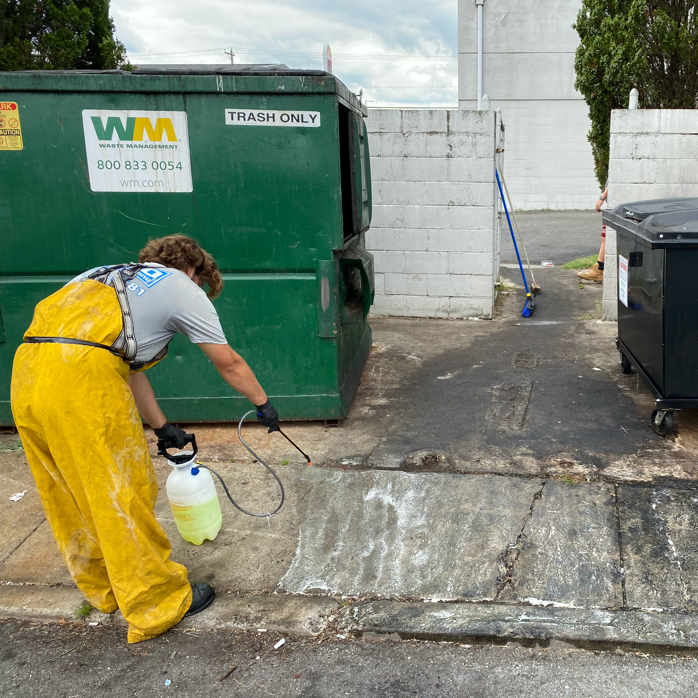 Commercial Cleaning company cleaning a dumpster pad in NJ