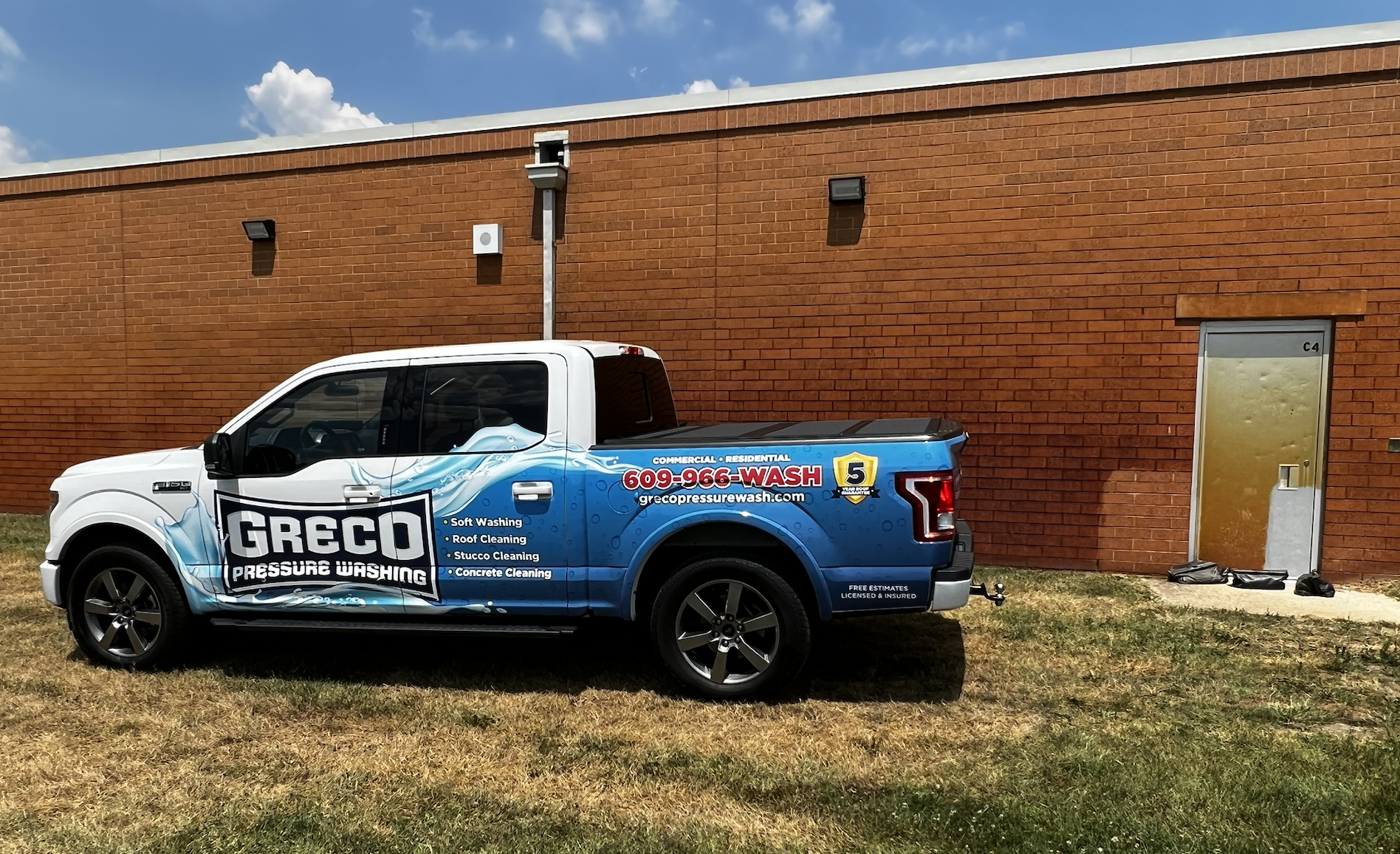 Pressure Wash Company performing a rust removal on a local school
